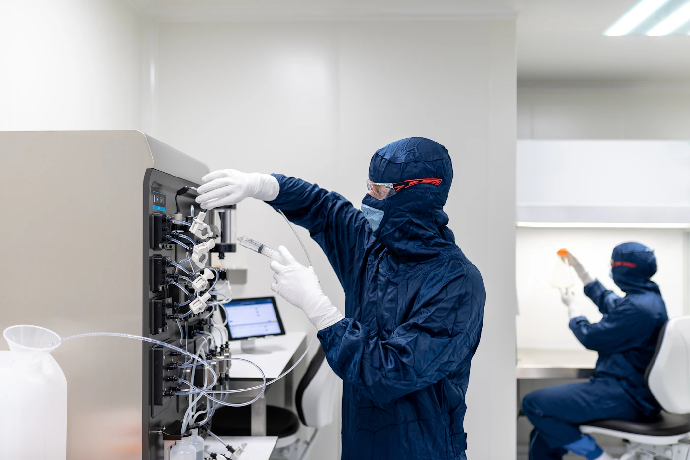 Laboratory technicians working with controlled equipment